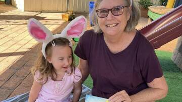 Isabella Westaway and Mary Elton enjoy an Easter Story. Photo by Judith Westaway.