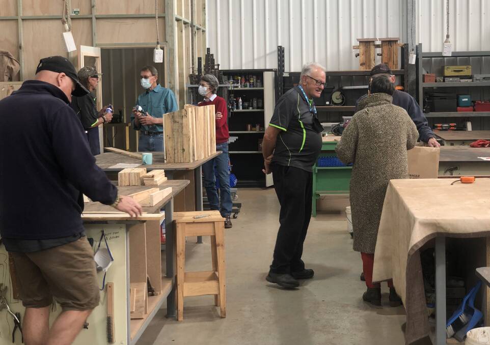 John Turnbull chats with a member of the public at the Margaret River Men's Shed. Picture supplied. 