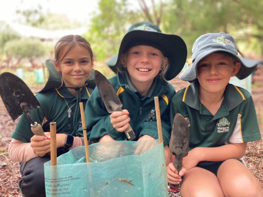 Margaret River Primary School students worked along the Margaret River, planting, staking and bagging native trees and shrubs, and removing weeds.